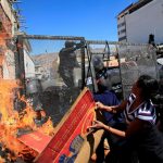 Demonstrators try to set fire to a police barricade, during a protest by people with physical disabilities demanding the government to increase their monthly disability subsidy, in La Paz